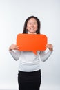 Portrait of cheerful young woman holding red bubble speech over white background Royalty Free Stock Photo