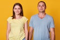 Portrait of cheerful young woman and man dressed in casual t shirts, looking and smiling directly at camera. Happy couple spending Royalty Free Stock Photo
