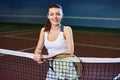 Smiling Young Woman Posing in Tennis Court Royalty Free Stock Photo