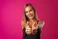 Portrait of a cheerful young woman showing thumbs up sign Royalty Free Stock Photo