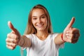 Portrait of a cheerful young woman showing thumbs up sign Royalty Free Stock Photo