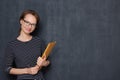 Portrait of cheerful young woman smiling and holding folder and pen Royalty Free Stock Photo