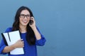 Portrait of cheerful young woman talking on smartphone outdoors. Happy beautiful Hispanic woman using mobile phone, making call Royalty Free Stock Photo