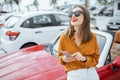 Woman with phone at the car parking Royalty Free Stock Photo