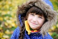 Portrait of cheerfull child girl in blue coat
