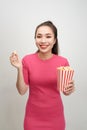 Portrait of a cheery pretty girl eating popcorn isolated over white background Royalty Free Stock Photo