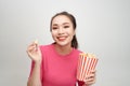 Portrait of a cheery pretty girl eating popcorn isolated over white background Royalty Free Stock Photo