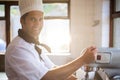 Portrait of chef blending the batter in mixing blender