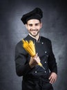 Portrait of a chef cooker in black uniform with spaghetti. Royalty Free Stock Photo