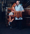 A chef and his female helper in a sausage storage.