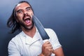 Portrait of chef with knife on gray background Royalty Free Stock Photo