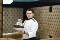 Portrait chef presenting a dish at the hotel restaurant, steaming a dish with a cover lid