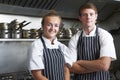 Portrait Of Chef And Trainee In Kitchen Royalty Free Stock Photo