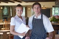 Portrait Of Chef And Waitress In Restaurant Royalty Free Stock Photo