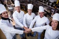 Portrait of chefs team putting hands together and cheering Royalty Free Stock Photo