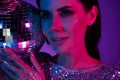 Portrait of chic classy lady dj on discotheque with disco ball christmas event neon futuristic background