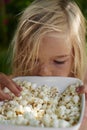 Portrait of Child Blond Girl eating popcorn Royalty Free Stock Photo