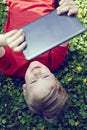 Portrait of Child blond young boy playing with a digital tablet Royalty Free Stock Photo