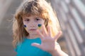 Portrait of child boy calls to Stop war in Ukraine, Stop the war hand gestures. No war, stop war, russian aggression Royalty Free Stock Photo