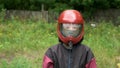 Portrait of child boy in costume and helmet to flying in aerodynamic tube.