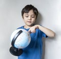 Portrait child boy is looking at a globe, Selective focus School kid  learning about Geography, Education and Home schooling Royalty Free Stock Photo