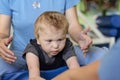 Portrait of a child with cerebral palsy on physiotherapy in a children therapy center. Boy with disability has therapy by doing Royalty Free Stock Photo