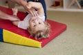 Portrait of a child with cerebral palsy on physiotherapy in a children therapy center. Boy with disability has therapy by doing Royalty Free Stock Photo