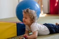 Portrait of a child with cerebral palsy on physiotherapy in a children therapy center. Boy with disability has therapy by doing Royalty Free Stock Photo