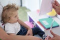 Portrait of a child with cerebral palsy on physiotherapy in a children therapy center. Boy with disability has therapy by doing Royalty Free Stock Photo