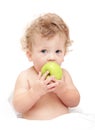 Portrait of a child curly hair eats a green ÃÂ°pple Royalty Free Stock Photo