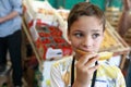 Child eating melon in market