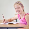 Portrait, child and education of student taking notes in classroom for knowledge, development and happy. Smile, girl and Royalty Free Stock Photo