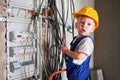 Little boy repairing electric cable in apartment under renovation. Royalty Free Stock Photo