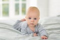 Portrait of a child four months on bed.