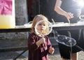 Portrait of child girl blowing big soap bubble. Real shot