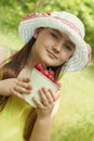 Portrait of child girl with bucket of strawberries