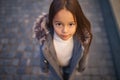 Portrait of a child girl in a coat with a fur hood Royalty Free Stock Photo
