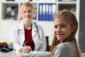 Portrait of child girl winks at camera in doctor office Royalty Free Stock Photo