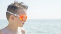 Portrait of a child in glasses for swimming against the sea. Kid in spectacles for swimming at the sea. Portrait of playful boy in Royalty Free Stock Photo