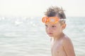 Portrait of a child in glasses for swimming against the sea. Kid in spectacles for swimming at the sea. Portrait of playful boy in Royalty Free Stock Photo