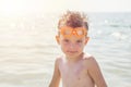 Portrait of a child in glasses for swimming against the sea. Kid in spectacles for swimming at the sea. Portrait of playful boy in Royalty Free Stock Photo