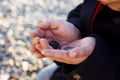 PORTRAIT CHILD HANDS PLAYING WITH A ROCK AND A BUTTON. CHILDHOOD TREASURE CONCEPT