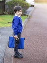 Portrait of Child holding toy and carrying bag waiting for schoolbus, Pupil of primary school get ready to studying, Student back