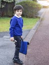 Portrait of Child holding toy and carrying bag waiting for schoolbus, Pupil of primary school get ready to studying, Student back