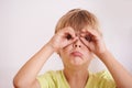 Portrait, child or kid and hands like glasses, playful and goofy on white background. Young boy or toddler, mischievous Royalty Free Stock Photo