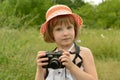 Portrait of a child, kid photographer a little girl with a camera on the background of nature. Royalty Free Stock Photo