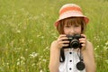 Portrait of a child, kid photographer a little girl with a camera on the background of nature. Royalty Free Stock Photo