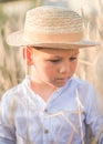 Portrait child. Little boy on a wheat field in the sunlight over sunset sky background. Fresh air, environment concept Royalty Free Stock Photo