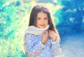 Portrait child little girl in sweater and scarf near branch tree