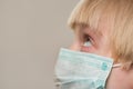 Portrait of child in medical mask, close up. Boy wearing protective face mask, prevent virus infection Royalty Free Stock Photo